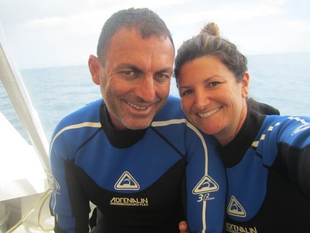 Couple in wetsuit on boat