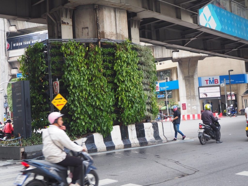 Notice the guy watering the vertical garden around a pillar that supports the train line above and has three lanes of traffic either side of if
