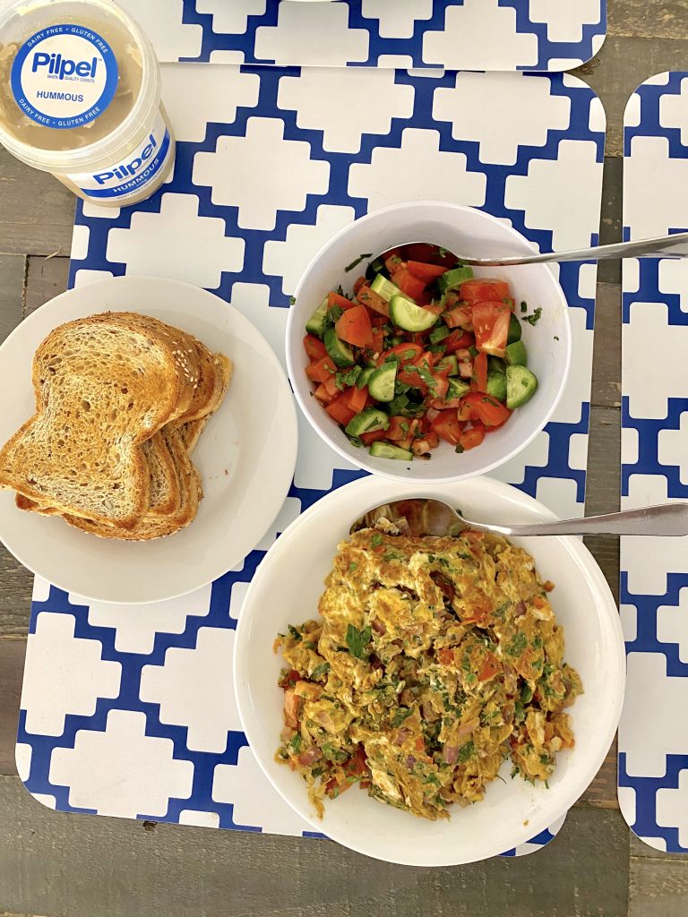 Bahraini Scrambled Eggs, tomato cucumber salad, toast overhead photo
