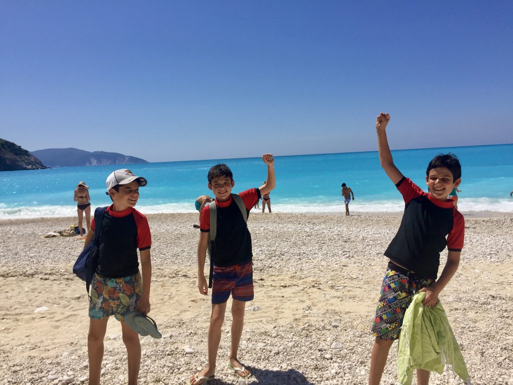 3 boys at Myrtos beach in Kefalonia, Greece