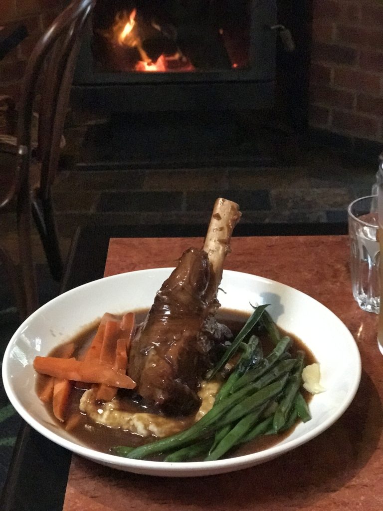 Lamb shank in front of a cosy fire at Settlers Tavern. Photo: Dianne Bortoletto