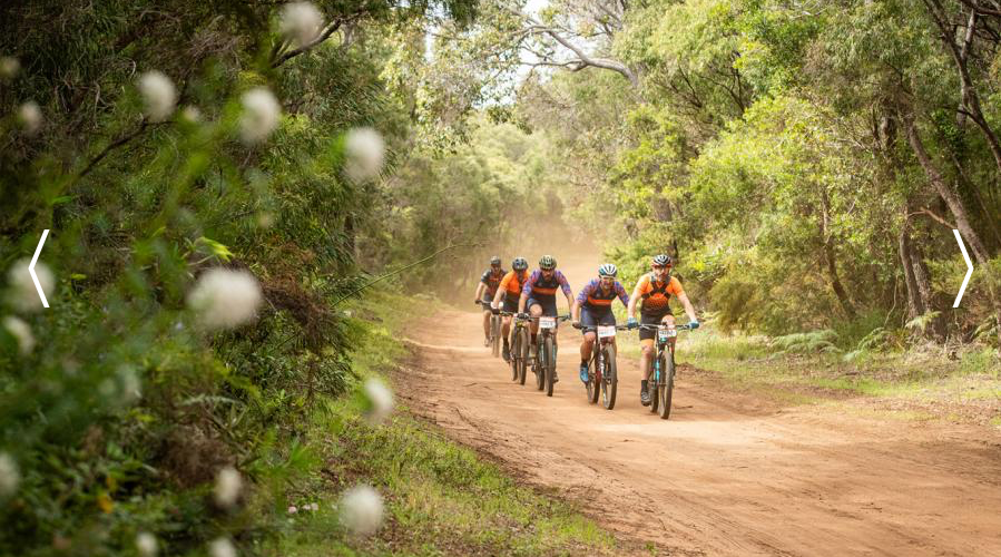 Mountain bikers racing on dirt road in Margaret River